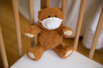 Teddy bear toy with a mask protected from a virus.