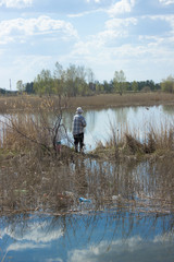 a duck sits on the water near the nest on a Sunny day