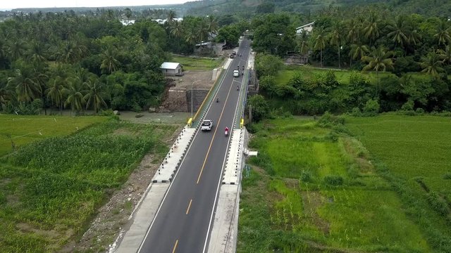 areal footage by drone the car runs between the fields, beautiful landscape Lombok Indonesia