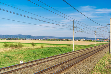 Fototapeta na wymiar Railroad tracks in the beautiful green landscape