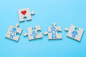 Happy family concept, people drawn on puzzles on the blue background.