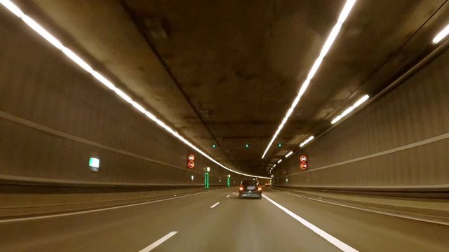 Following a car in several tunnels by a camera view from the front engine hood in Munich, germany