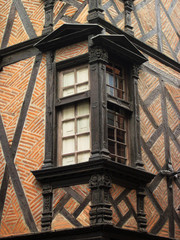 House with wooden formwork structure, windows and pediments in the corner. Historic city of Albi....