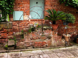 Fototapeta na wymiar Stairs and door. Brick house in the streets of the old city center of Albi. France. 