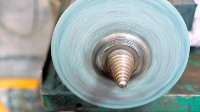 Grinding machine with abrasive wheel in the workshop.
