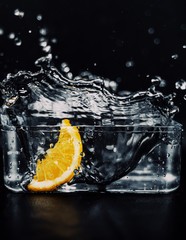Slice of a lemon, falling in aquarium full of water, making a very nice splash.