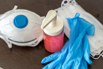 soap, medical gloves and respirators - personal protective equipment on the table at home

