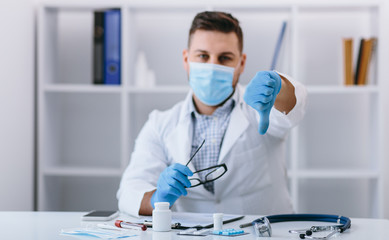 Angry man doctor in cabinet with bad finger sign