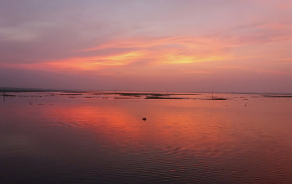 Beautiful  image of Bangladesh river with red sky in the background.