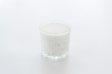 Milk shake with chia seeds. Glass of milk on a white background.