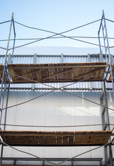 Fototapeta premium building wooden metal from scaffolding pipes bottom view background place for text