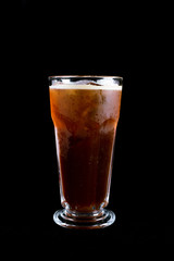 Glass of tasty iced coffee with black background, summer drink. energy drink,  