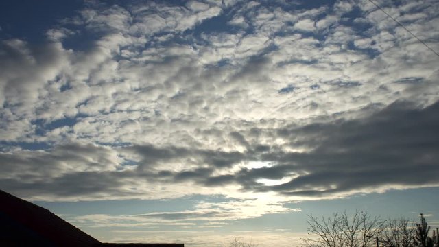 Time-lapse of a clouded sky with a bright sun during daytime
