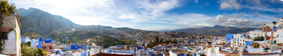 Fototapeta na wymiar Panoramic view to Chefchaouen town, Morocco. Famous brightly blue painted medina (old town). Idyllic background with Rif mountains and Blue City in the North of Morocco, Africa.