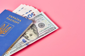 Passport of ukrainian citizen and banknotes on pink background. Concept of travel, donation or social payments