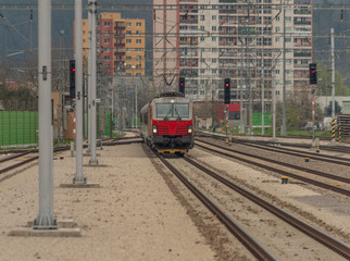 Fast passenger train with red modern electric engine in Trencin station