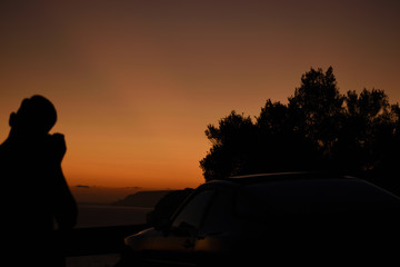 Fototapeta na wymiar silhouette of a man sitting on a car