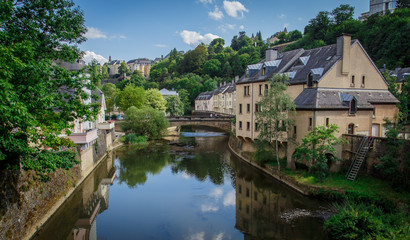 Fototapeta na wymiar View from the bridge to the river and the old city of Luxembourg on a sunny day.