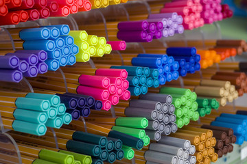 Different colors pens on store shelves. Art store, workshop, office supplies, stationery concept.