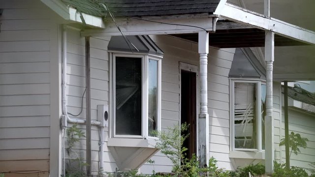 Abandoned spooky house at crime scene or damaged from severe weather like tornadoes or hurricanes.