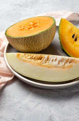 Fresh assortment melon with mint  on gray