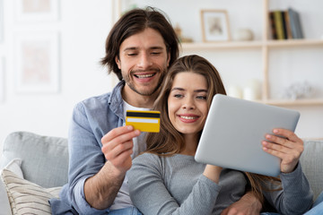 Positive man and woman making shopping online