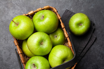 Ripe green apple fruits on dark stone table