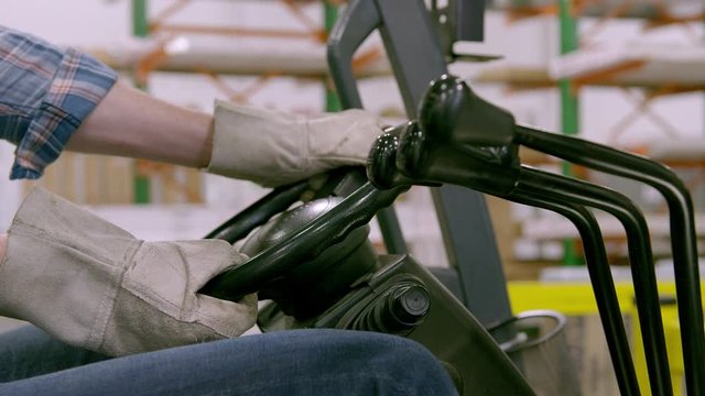 CU PAN Hands of man in gloves operating forklift