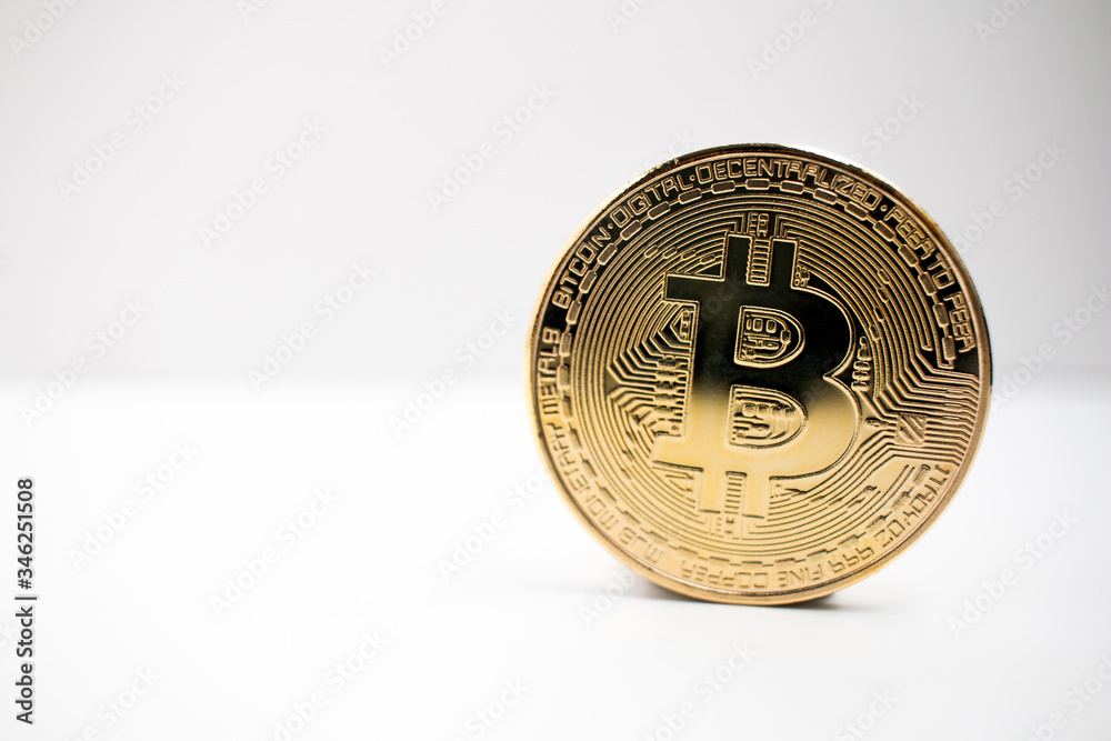 Wall mural closeup of a golden bitcoin coin with a white background. crypto currency.