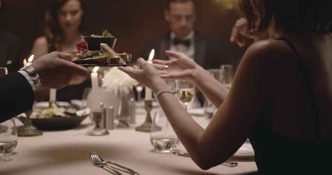Group of friends enjoying gala dinner party. Millennials enjoying dinner together.
