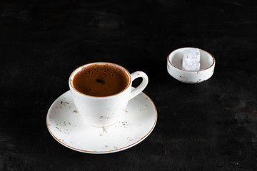 Obraz na płótnie Canvas Turkish Coffee with turkish delight on black wood table. coffee time, time to rest 