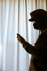 Hand of a man looking through window