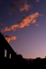 Fototapeta premium Houses on a suburban street silhouetted in evening sky