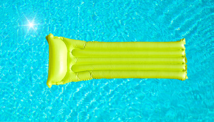 green inflatable mattress on blue pool