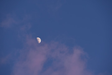 Night sky with clear view of the moon and craters on surface