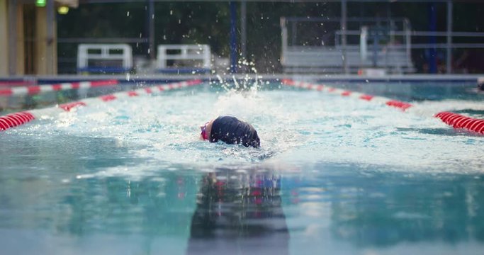 Female swimmer swimming freestyle in pool