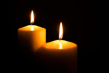 Flame candles isolated on black background. Close up.