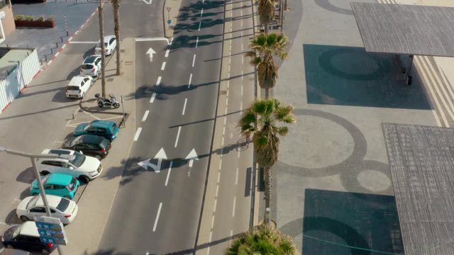 Food delivery cyclist on empty city street, coronavirus lockdown, aerial follow