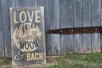 antique looking sign leaning against old wooden door