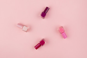 Nail Polish on a pink background. Manicure set with Sakura flowers flat lay. Close up с пространством для текста.