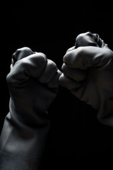 Fototapeta na wymiar Hand gestures stress anxiety double fists in tension Black Protective Gloves isolated on black background LOW KEY PPE, Hygiene, social distancing