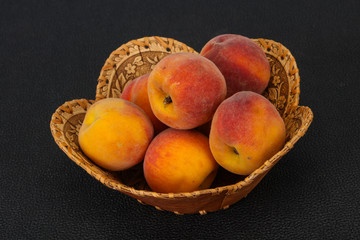 Peach heap in the wooden basket