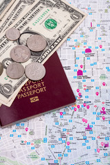 money and passport on top of a map