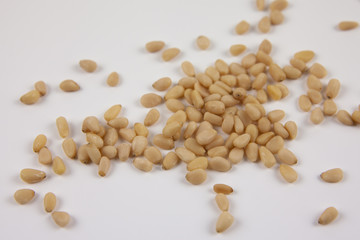 A handful of pine nuts on a white background. Healthy lifestyle. The ingredients for the dishes.