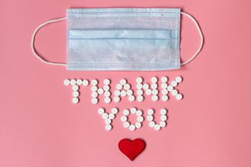 International's nurses day, week concept, Text Thank you by tablets and red heart on pink background.