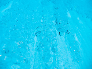 Blue ice background. Ice stalactites stalagmites. The ice of lake Baikal