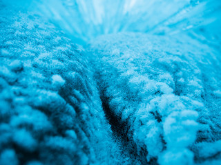 Blue ice background. Ice stalactites stalagmites. The ice of lake Baikal