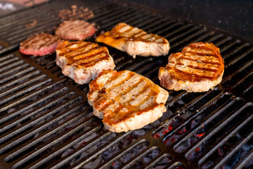 Entrecote Beef Steak On Grill With Rosemary Pepper And Salt - Barbecue.Grilled beef fillet steaks with herbs and spices.Beef steak on the grill grate. Barbecue and grill, delicious food.