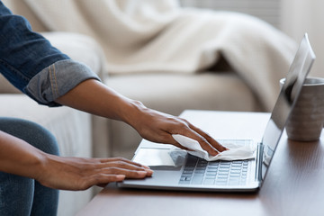 Coronavirus Cleaning Tips. Black Woman Sanitizing Laptop Keyboard With Antibacterial Wipes
