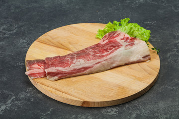 Raw beef bacon over wooden board